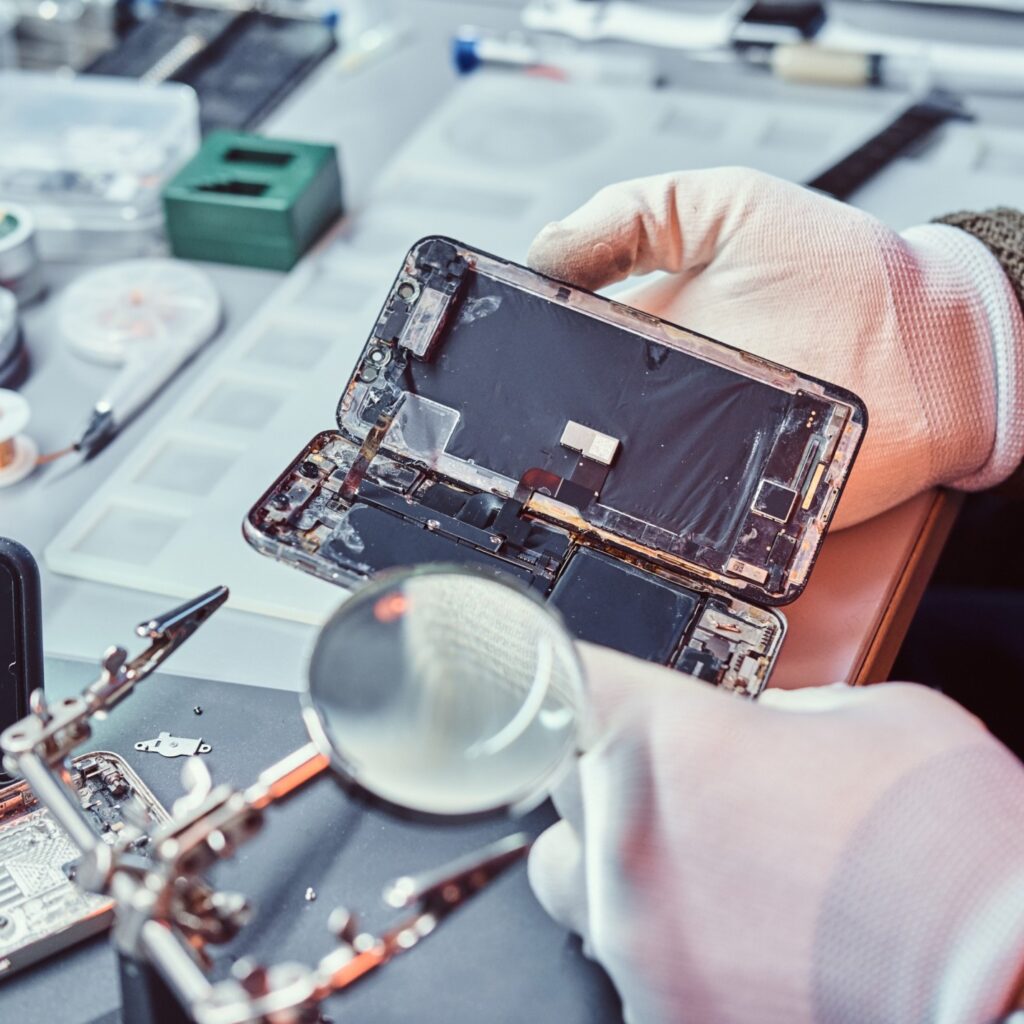 Local electronics repair shop in Wellington working on mobile devices
